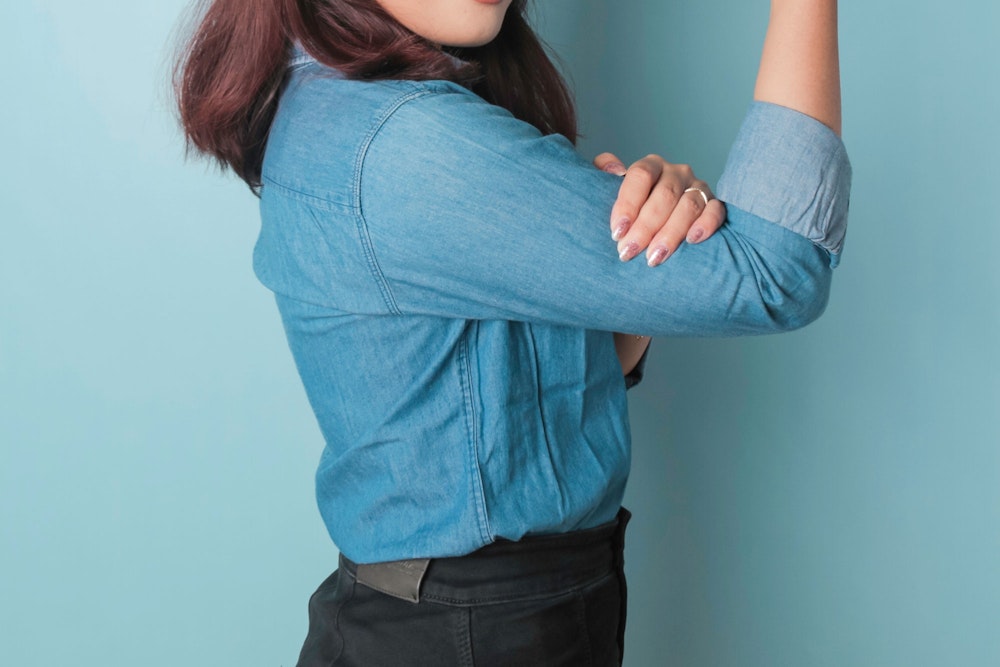 woman flexing her arm