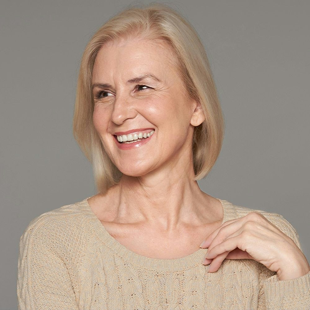 Smiling older woman looking over shoulder