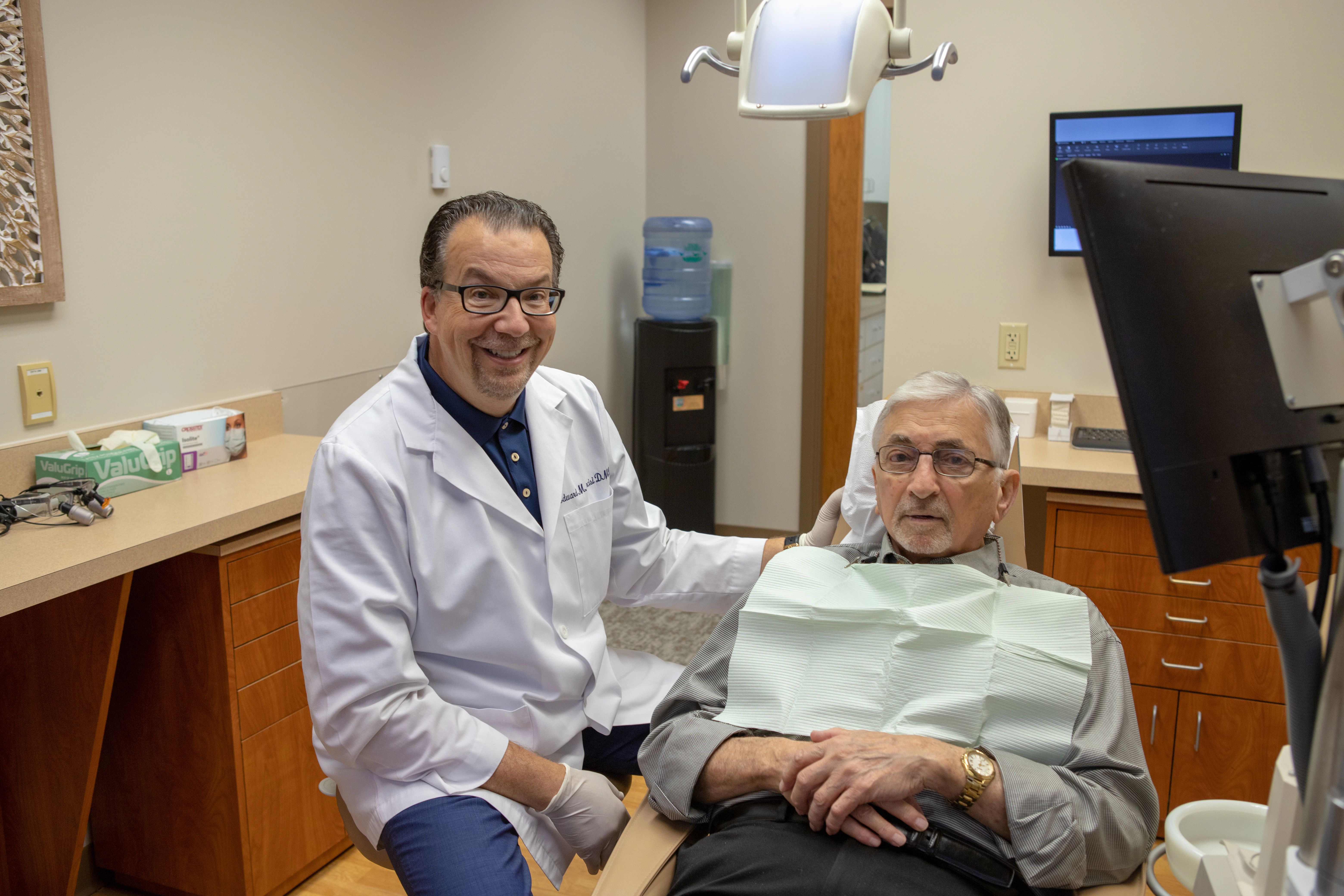 Dr. Narcisi and his patient in a treatment suite