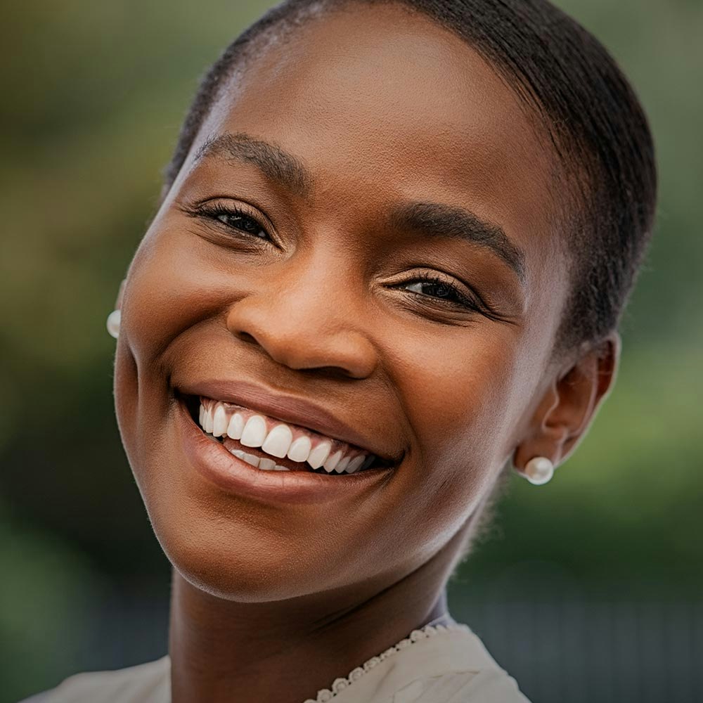 Young man with glasses smiling to the side