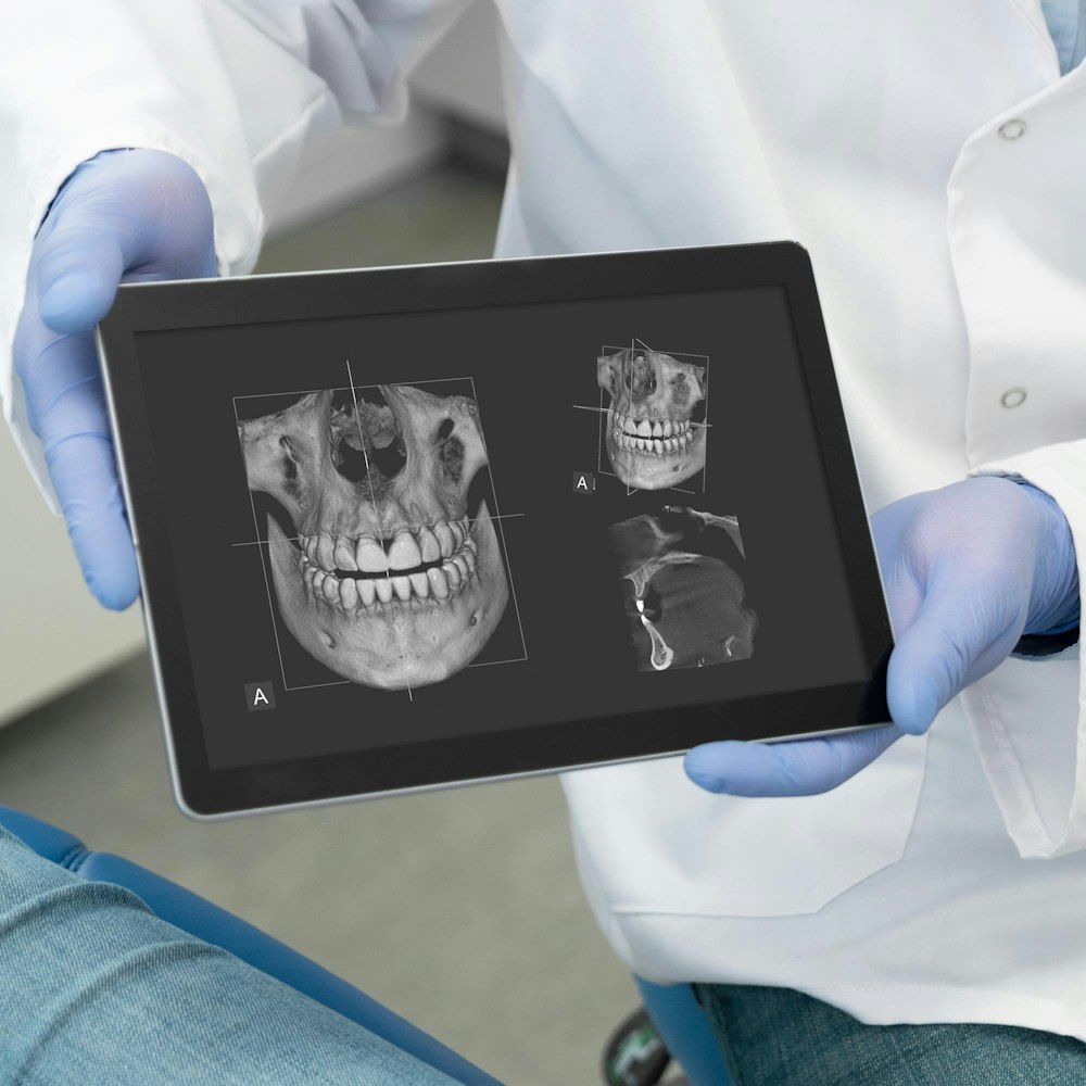 Dental professional holding imaging