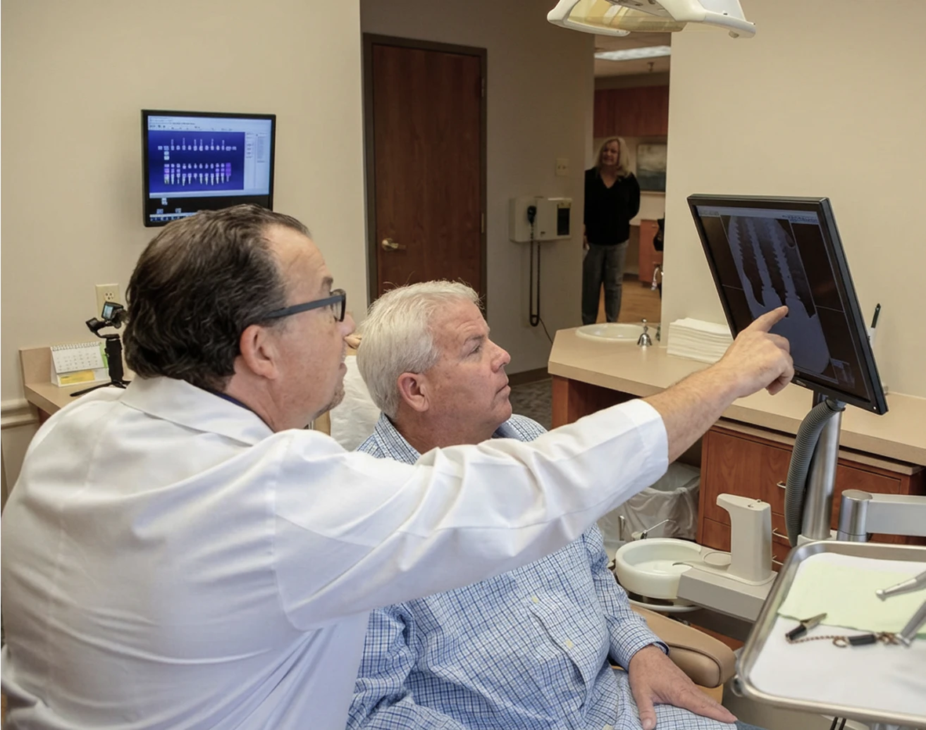 Dr. Narcisi looks at x-ray with patient