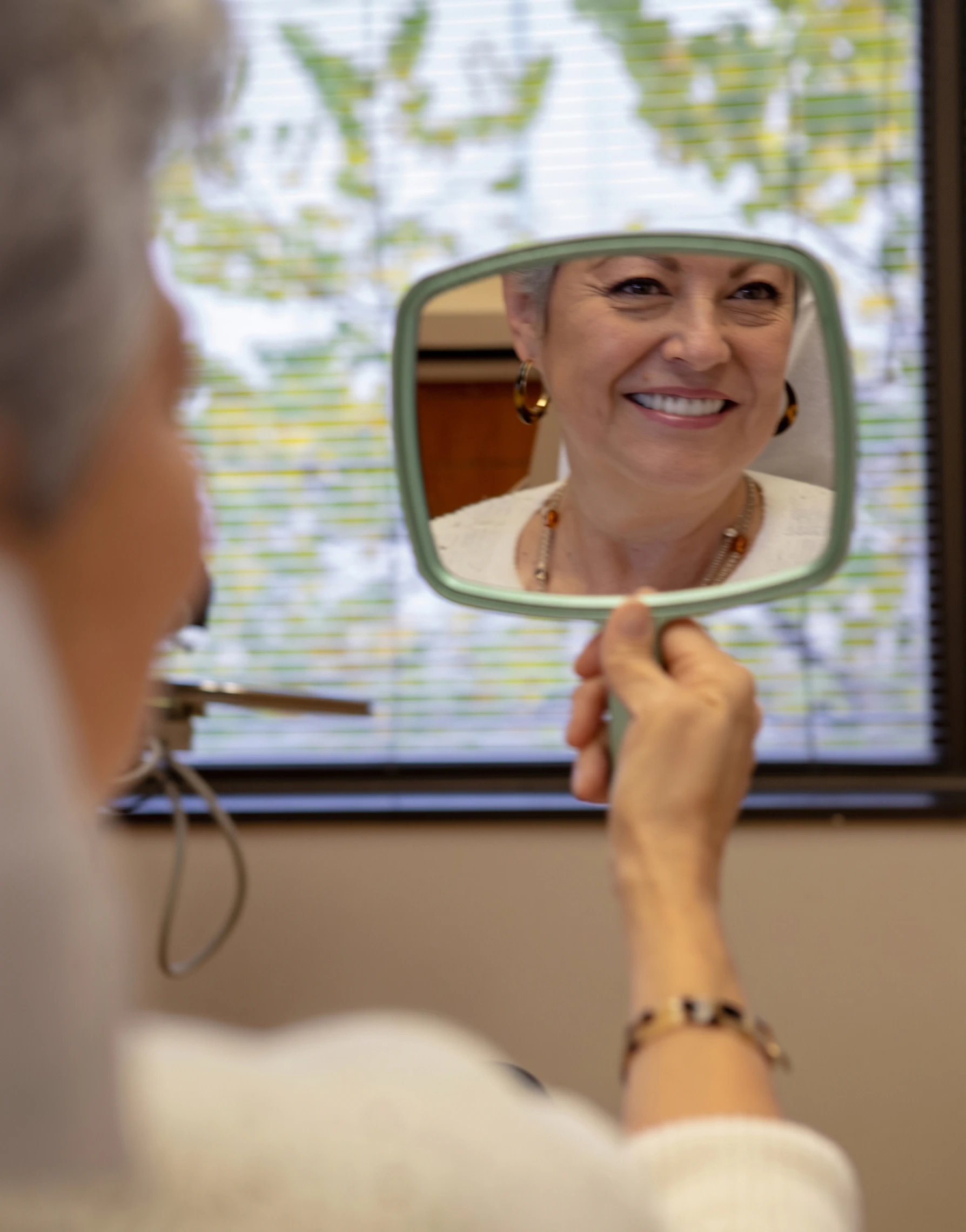 Woman admiring her restored smile