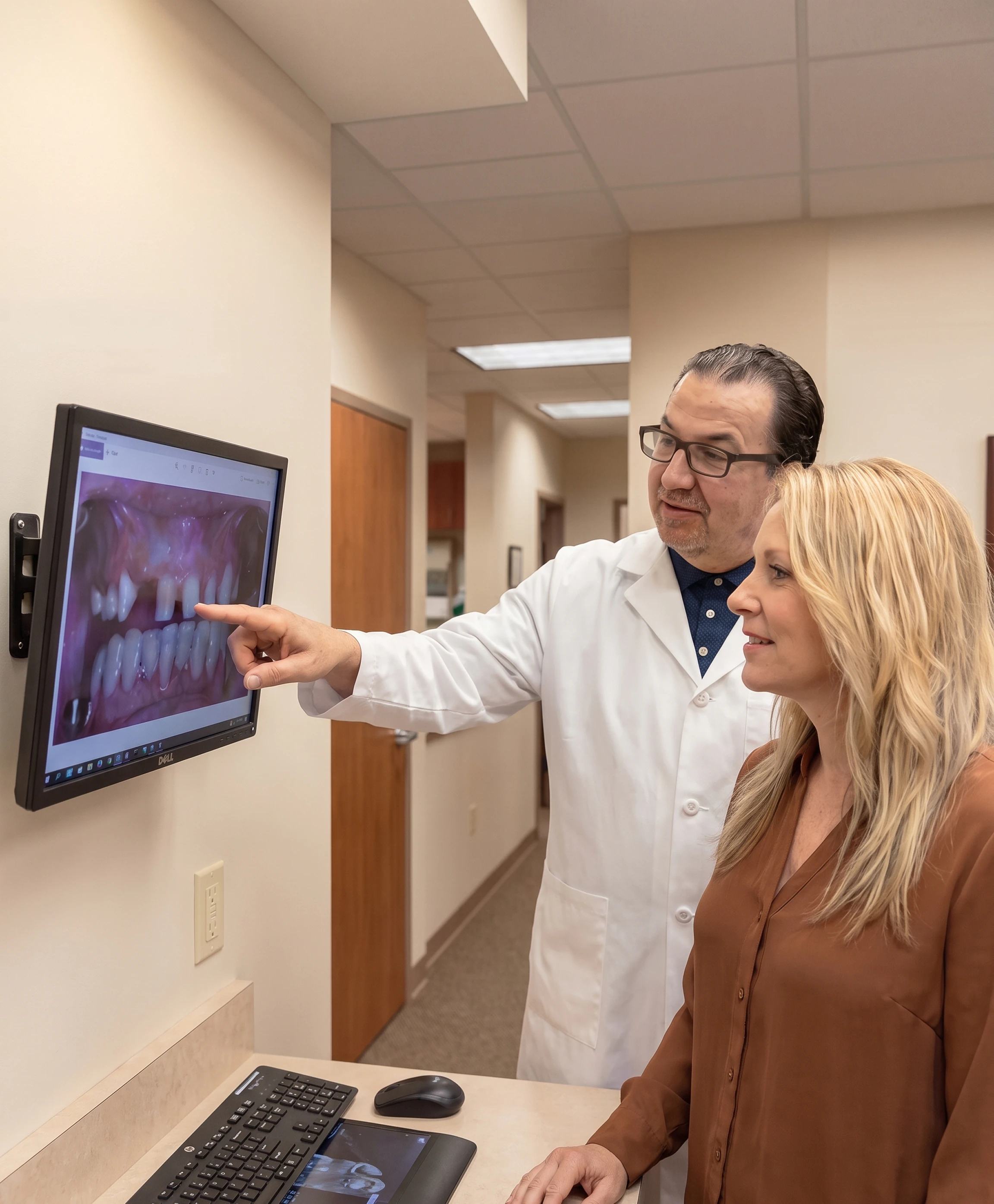 Dr. Narcisi reviews dental images with a patient