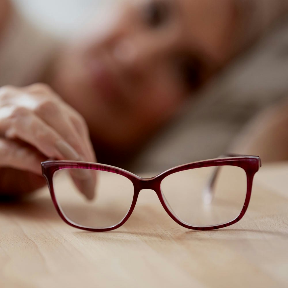 Mature woman reaching for glasses