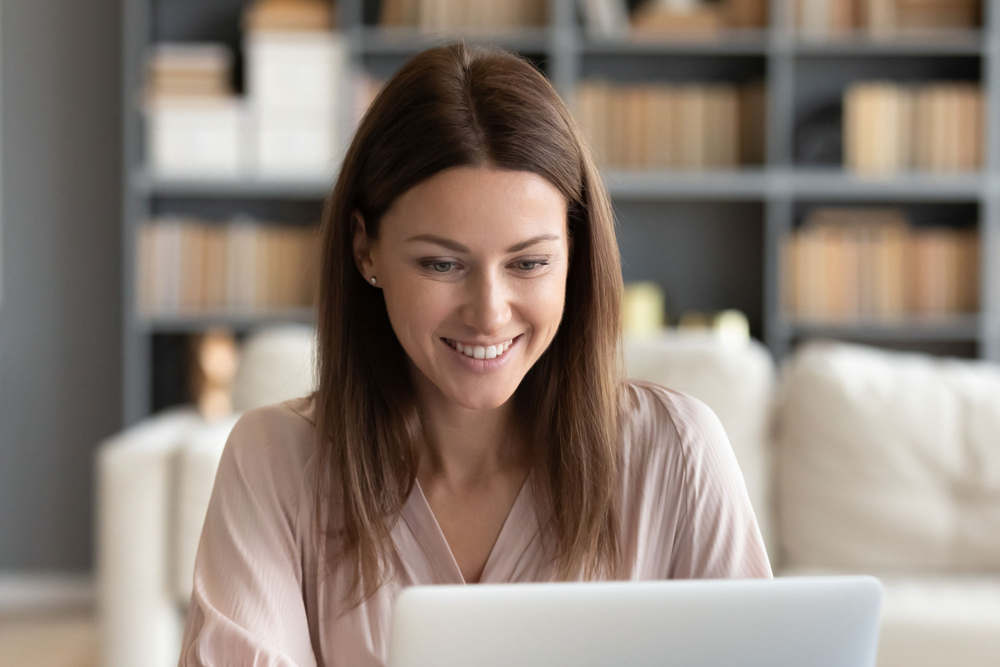 Woman messaging on laptop
