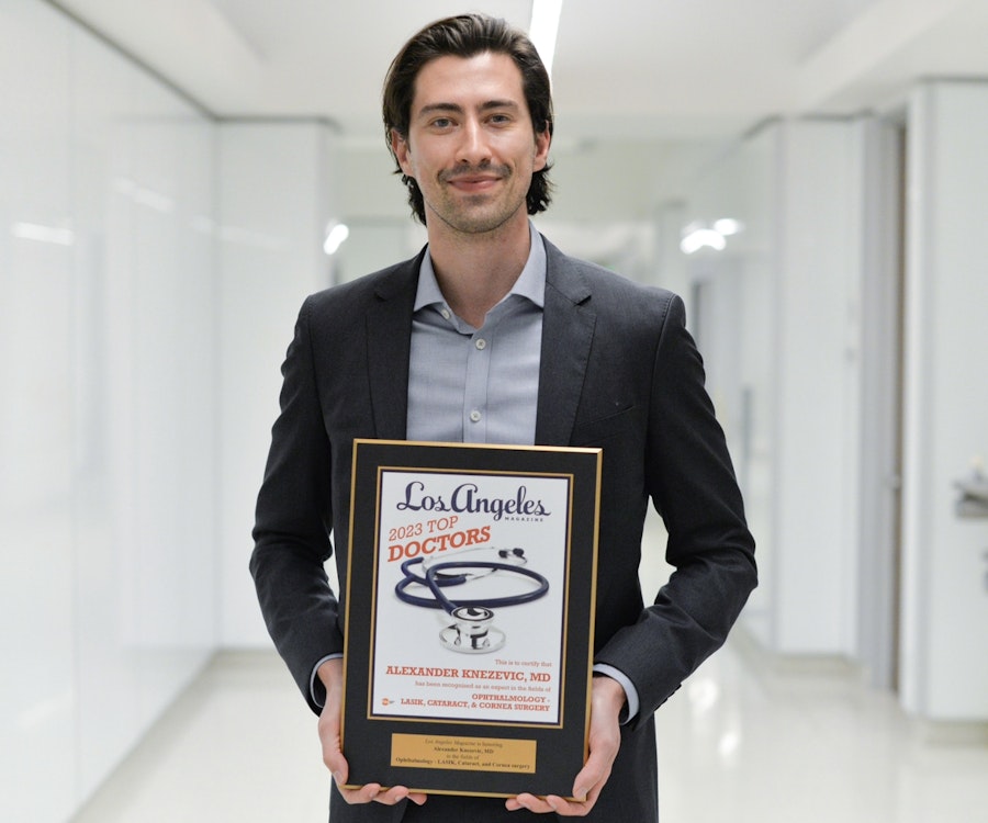 Dr. Alexander Knezevic holding an award