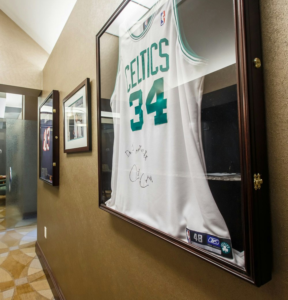Autographed Paul Pierce Celtics jersey hanging on office wall