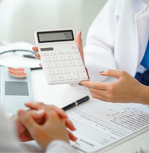 Dental staff holding calculator