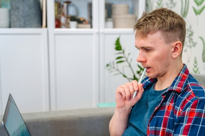 Man chewing on pen cap