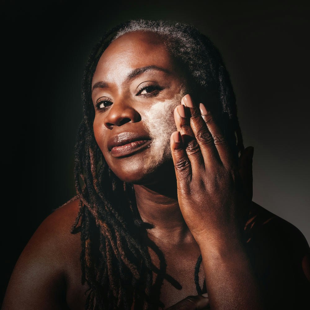 Woman applying skincare product on her face