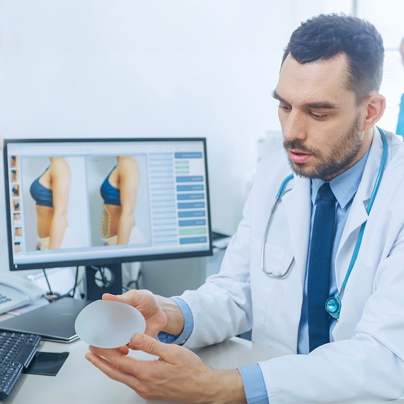 Doctor showing patient an implant and the after results