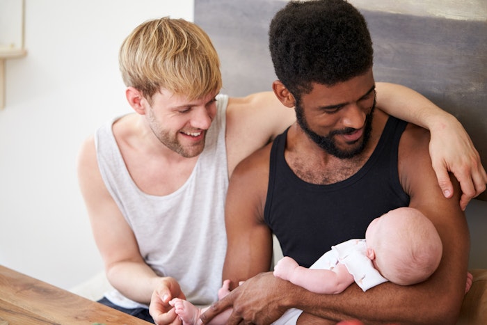 Gay couple holding baby