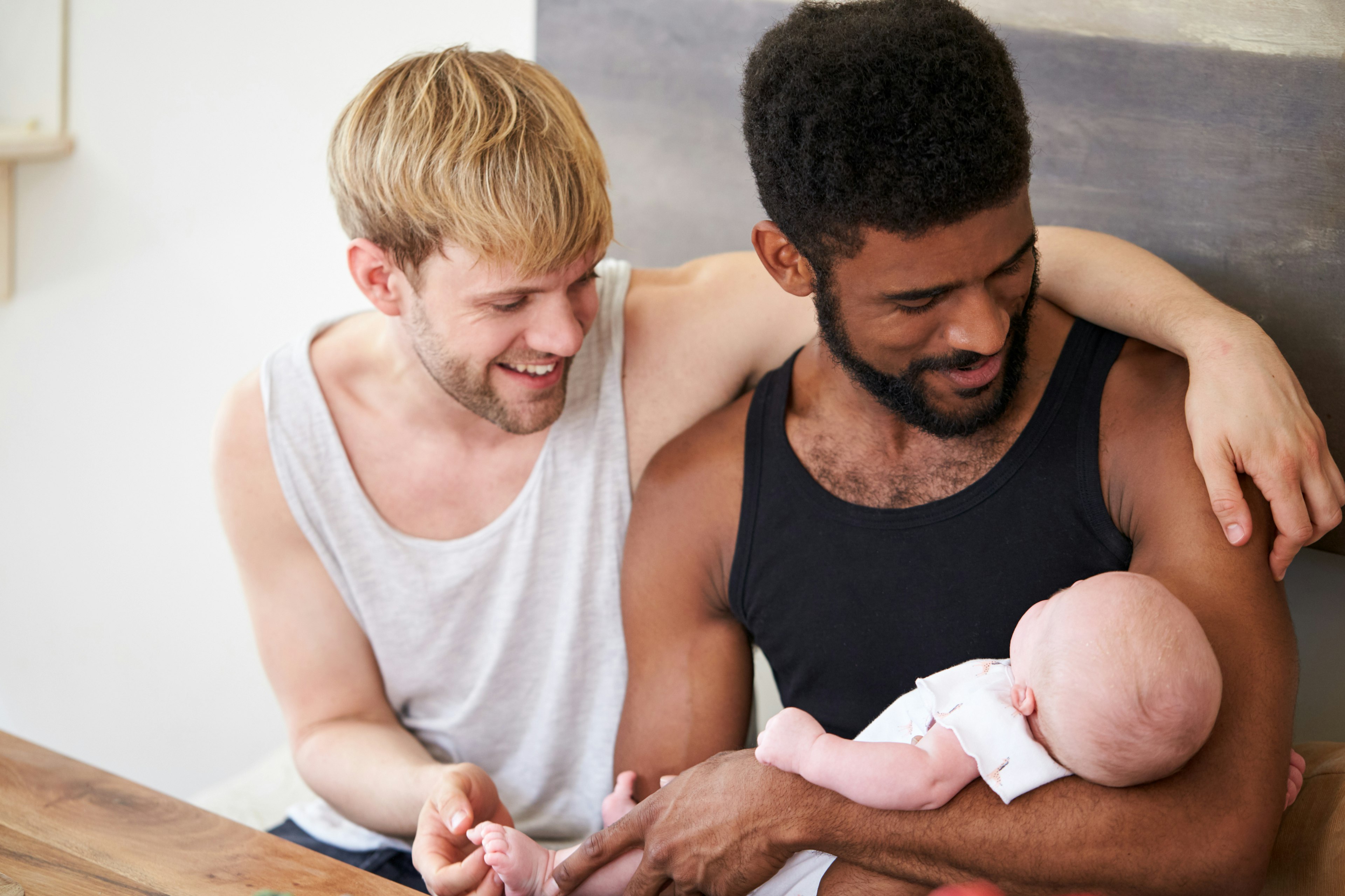 Gay couple holding baby