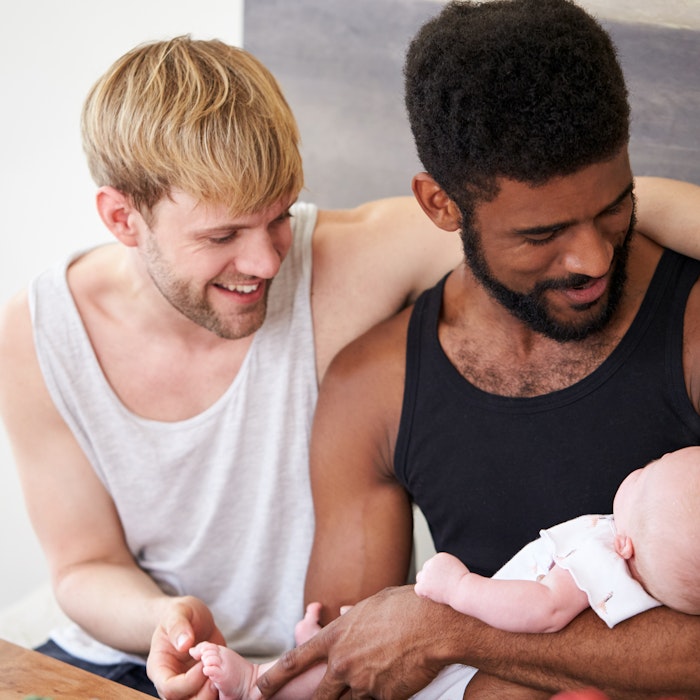 Gay couple holding baby