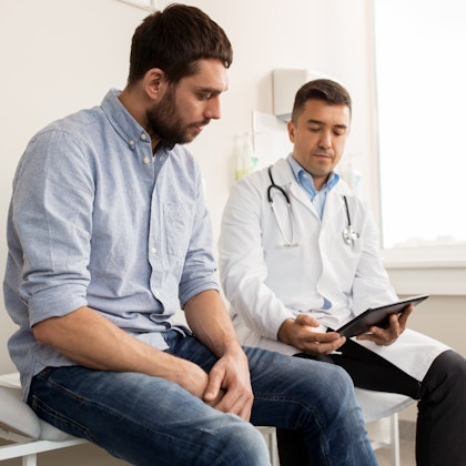 man and doctor looking at chart