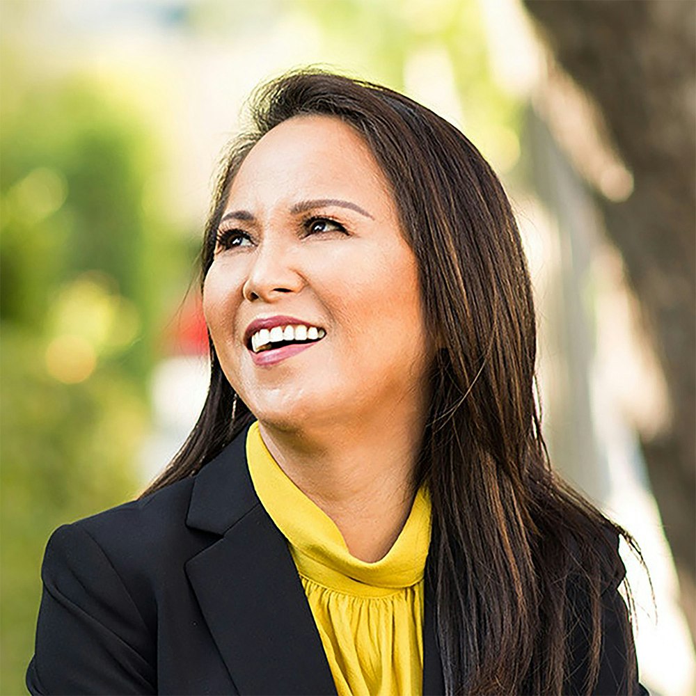 Middle-aged woman smiling after crowns and bridges treatment while walking outside