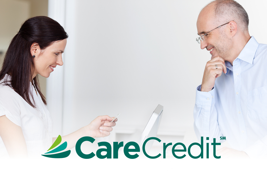 woman paying for her dental care with CareCredit logo