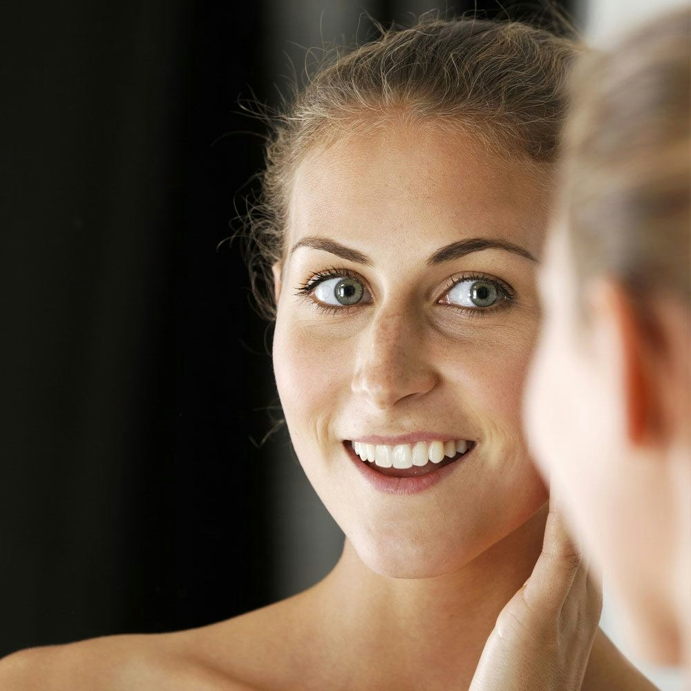 Woman smiling in the mirror