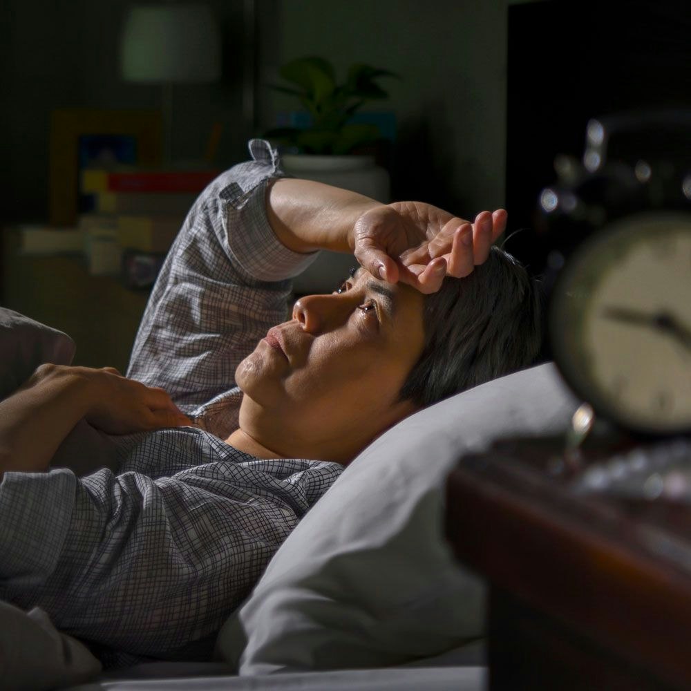 Person in bed unable to sleep