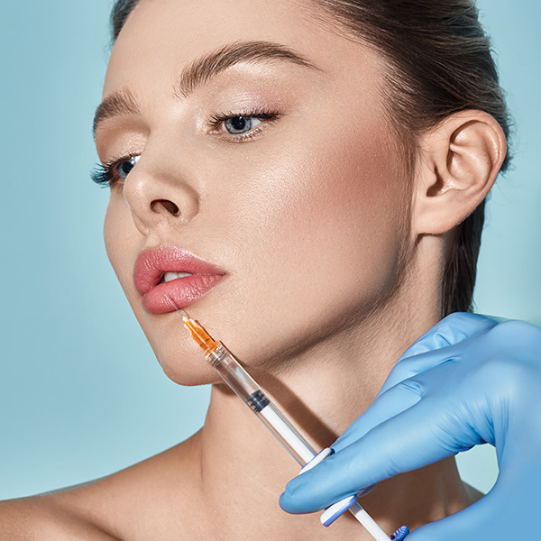 Needle next to woman's lips