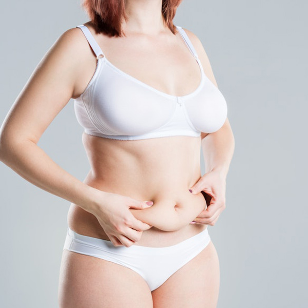 Woman pinching belly skin