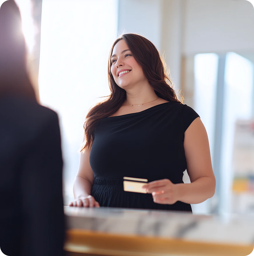 woman smiling holding credit card