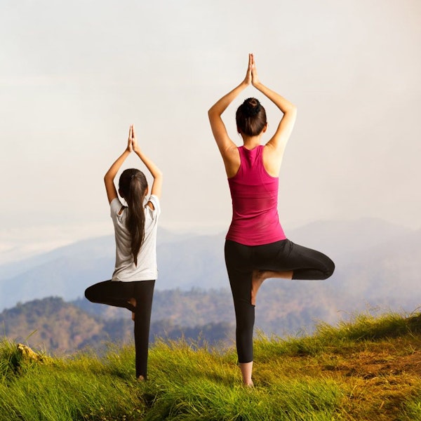 mother and daughter doing yoga