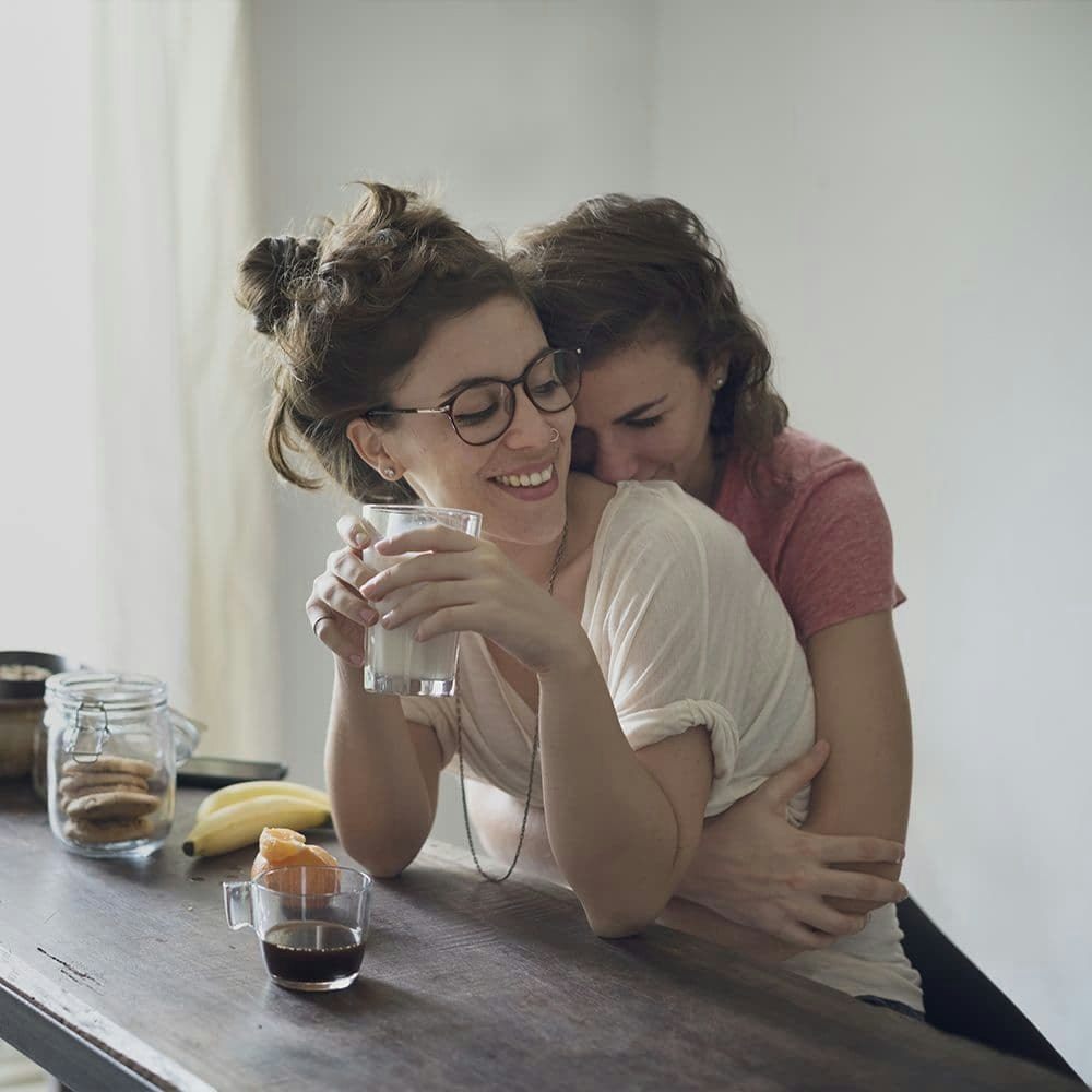 Woman hugging her partner from behind