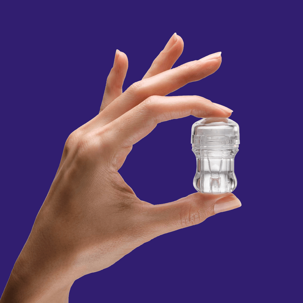 Hand holding an INVOcell device against a solid purple background