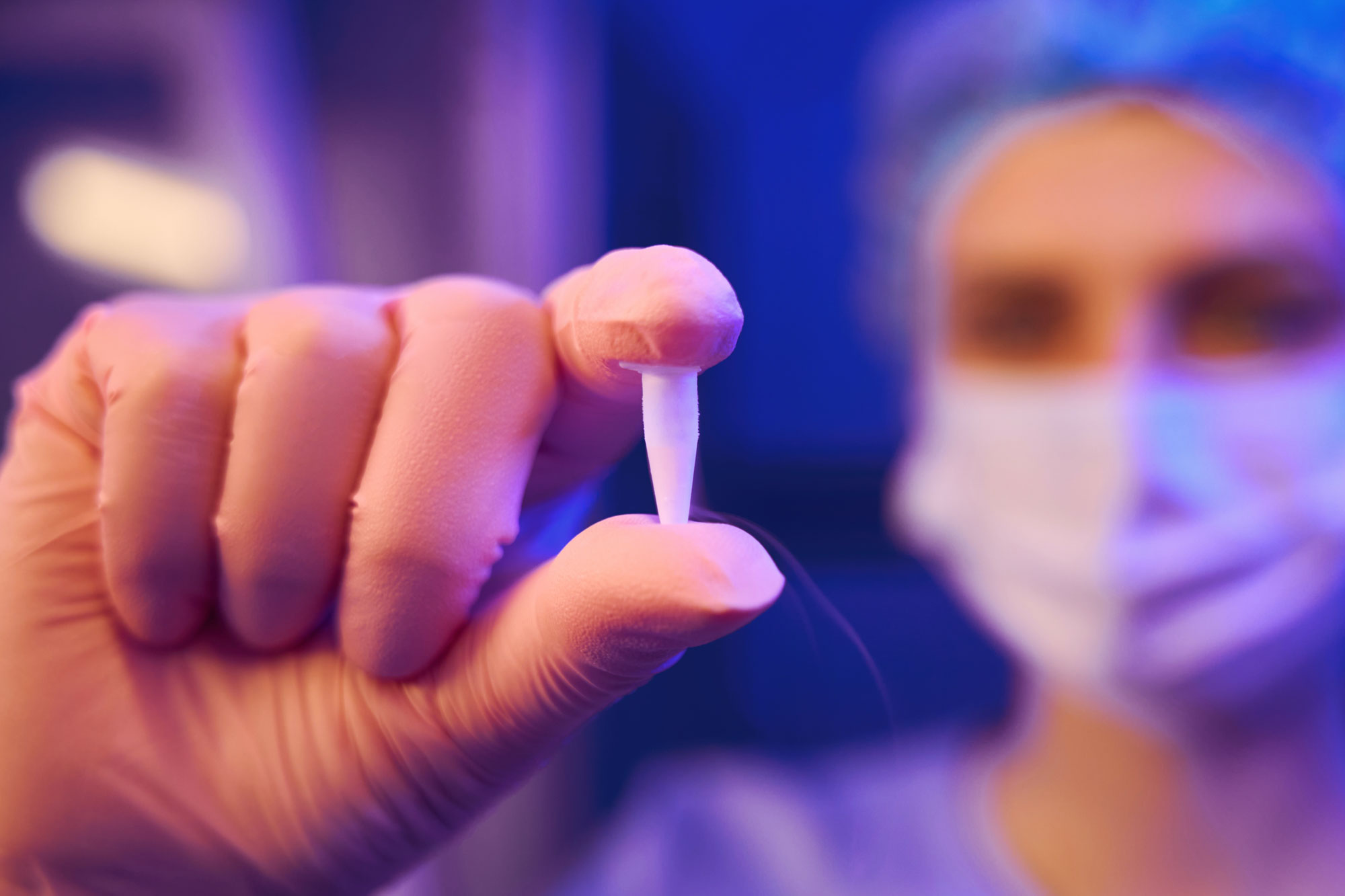 doctor holding up IVF instrument