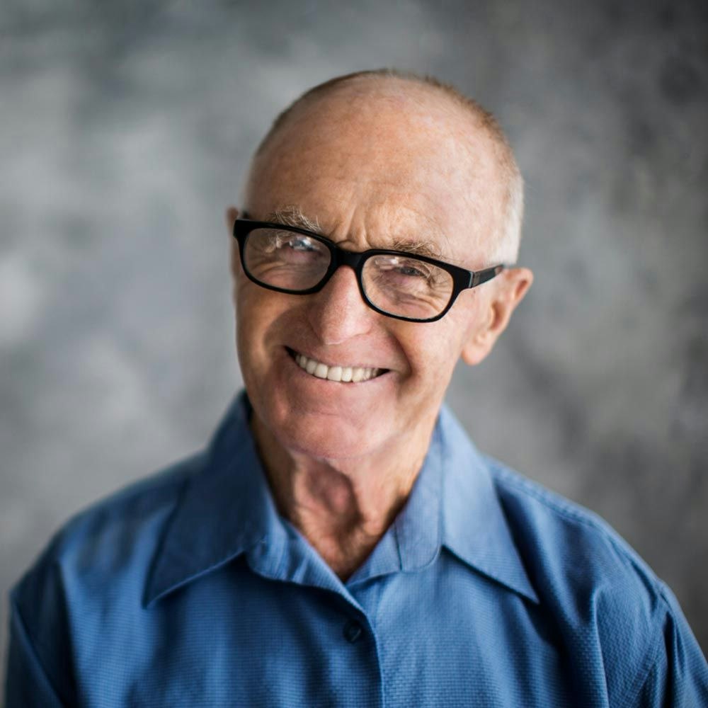 An older man with a complete smile