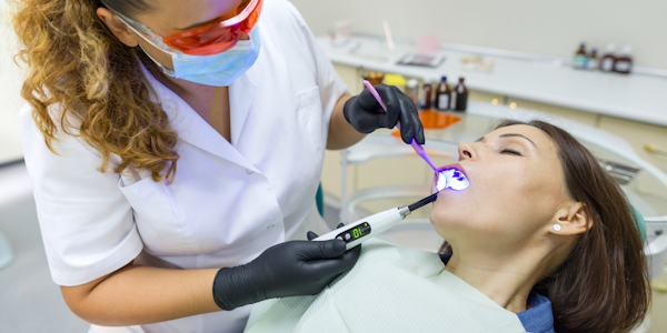 Dentist working on patient while they are sedated