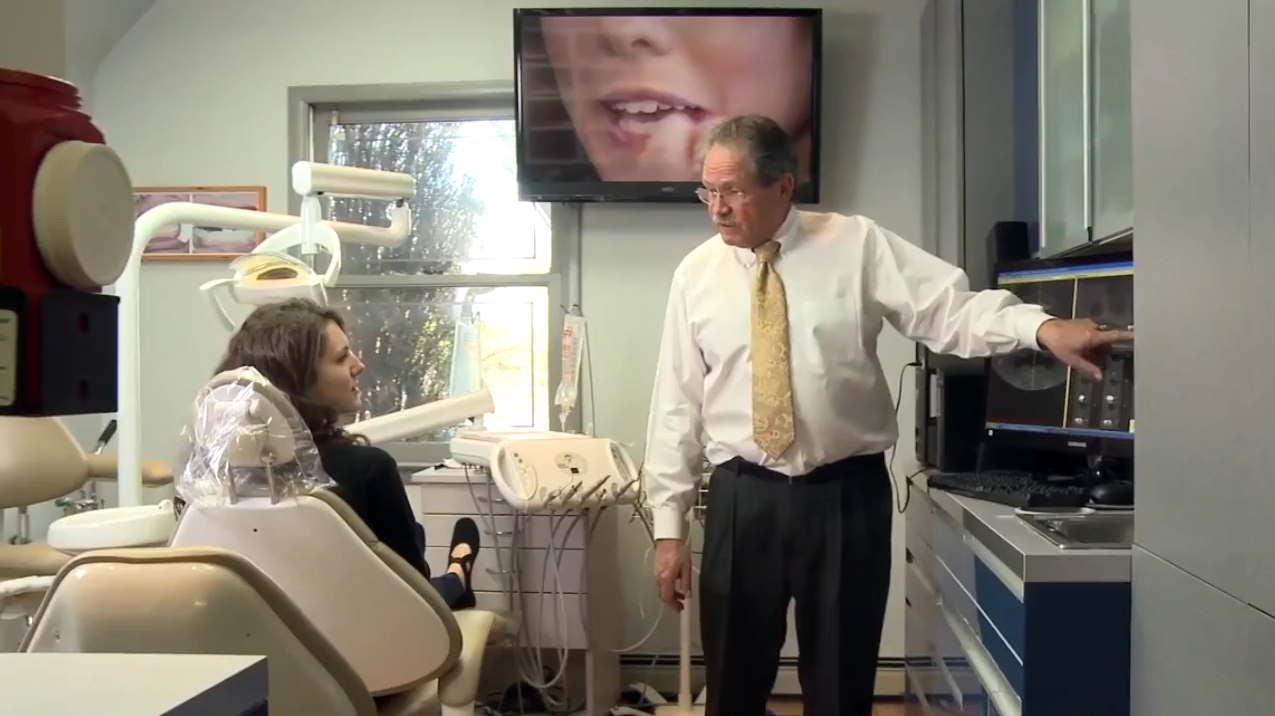 Dentist consulting with patient