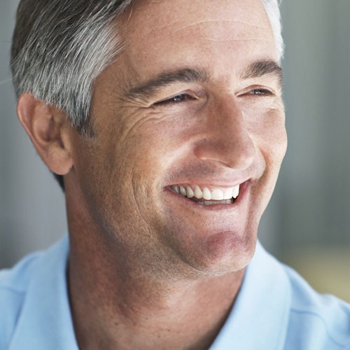 a smiling man after dental implants