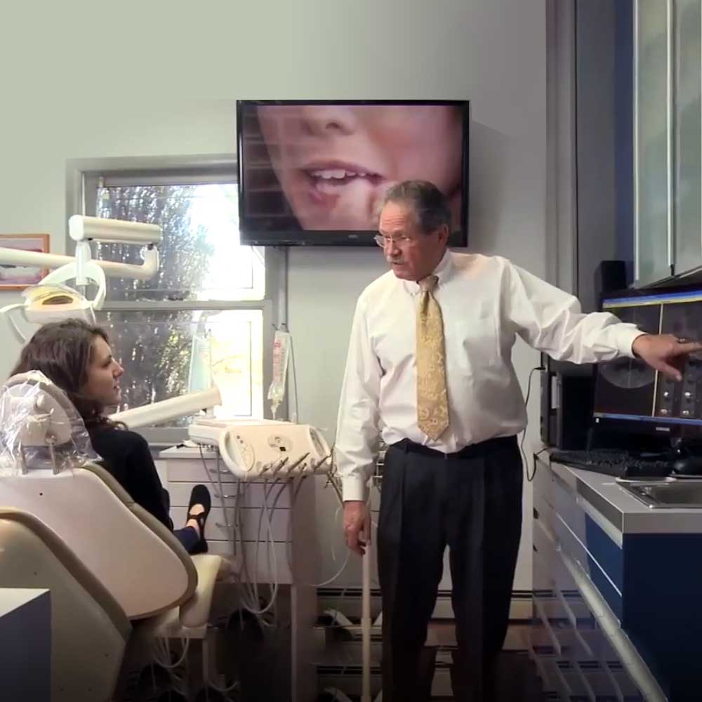 Dr. Hecht explaining treatment to a patient