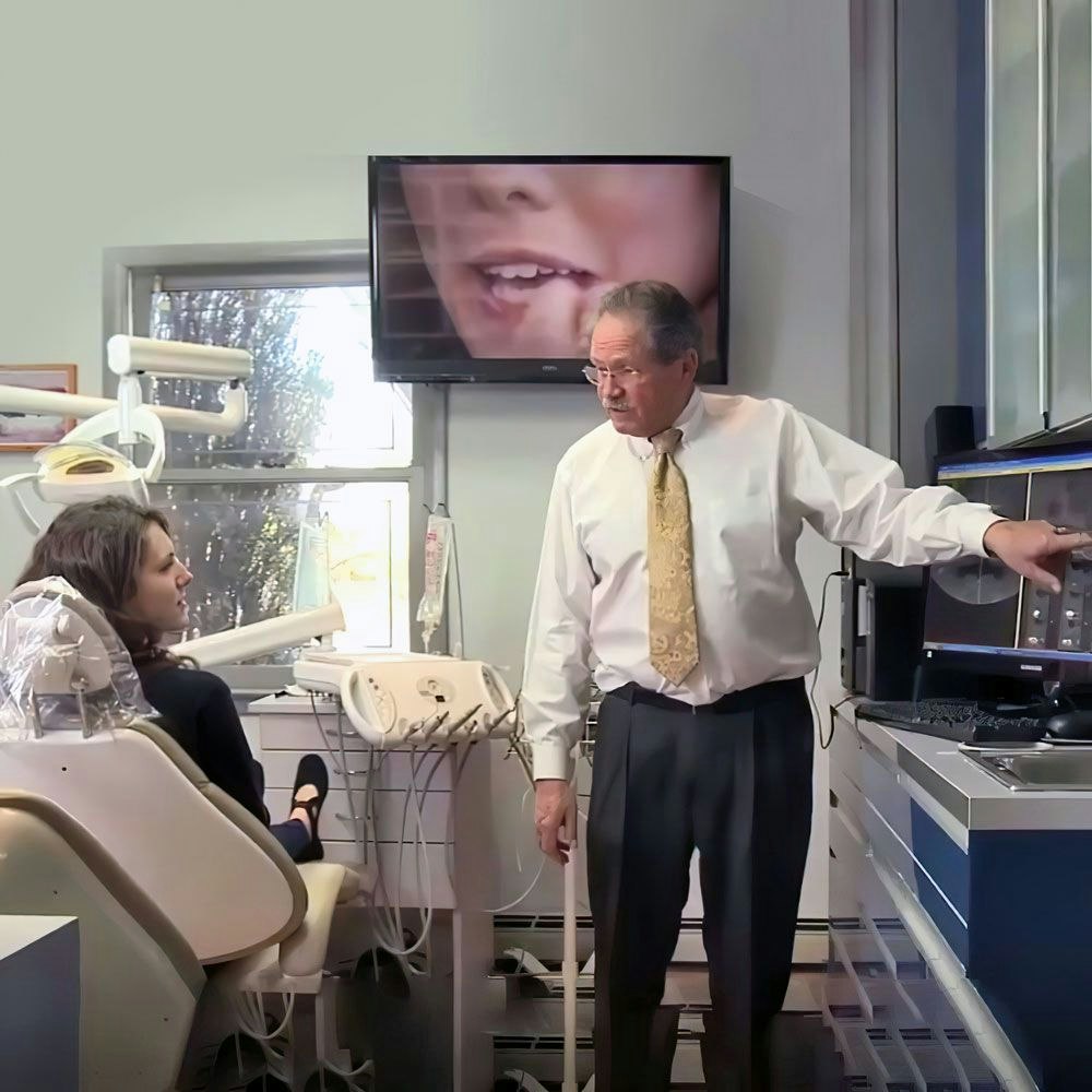 Alex Hecht, DDS consulting a patient