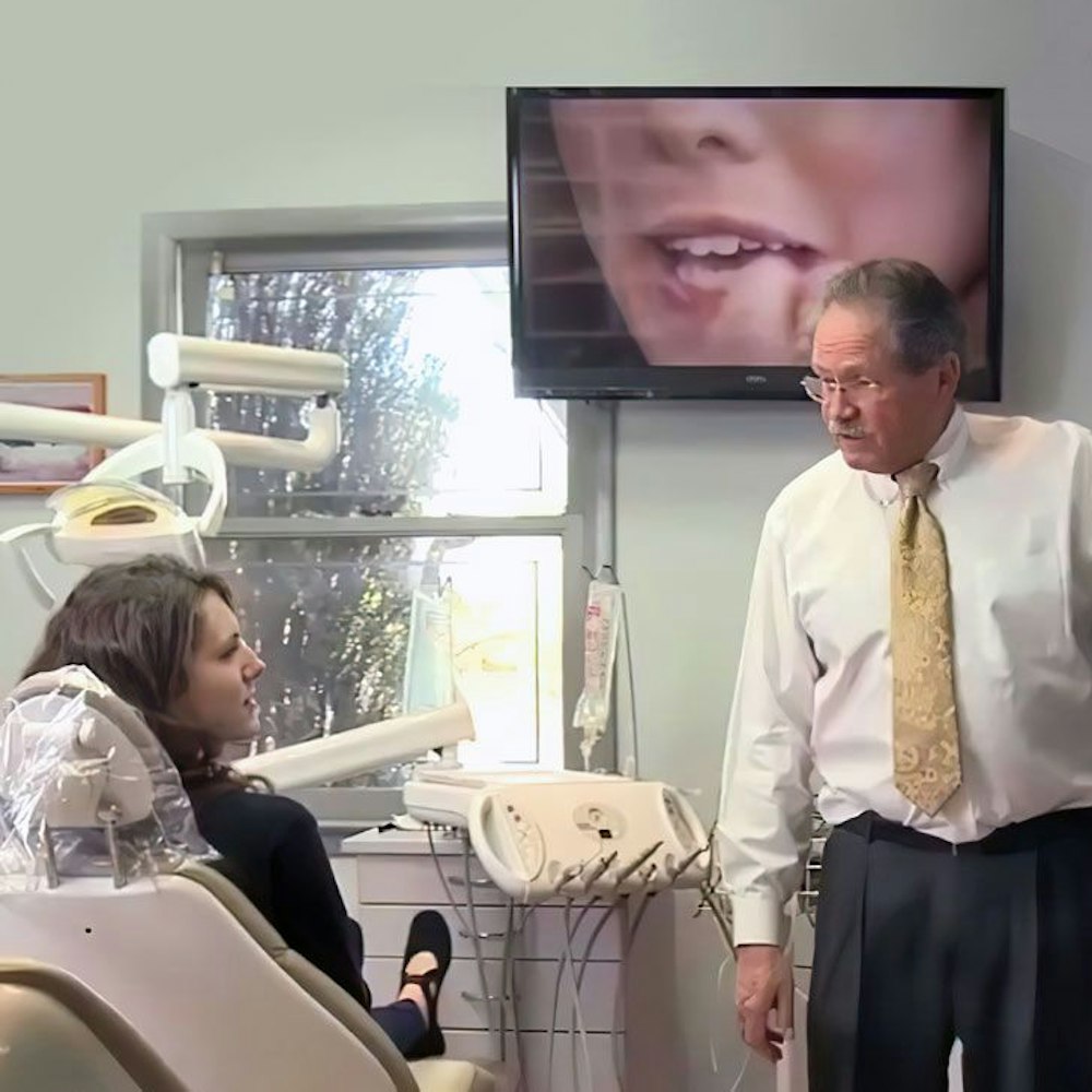 Alex Hecht, DDS consulting a patient