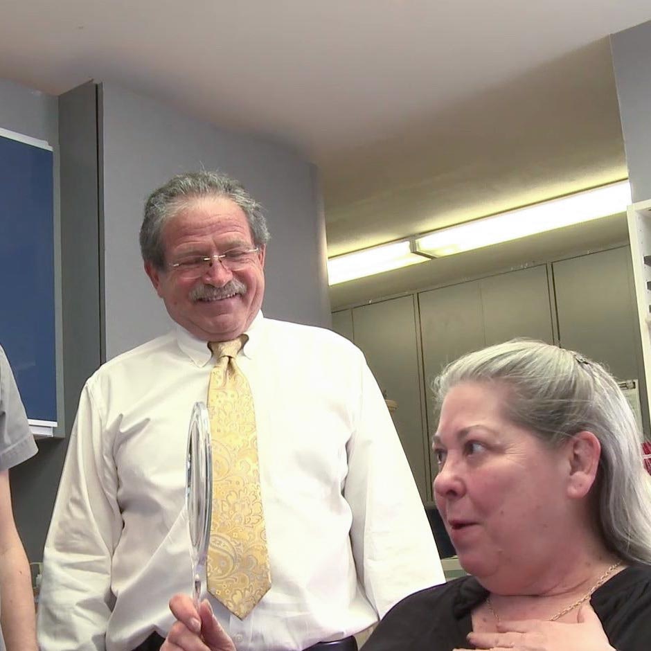 Dr. Alex and patient smiling at her new teeth