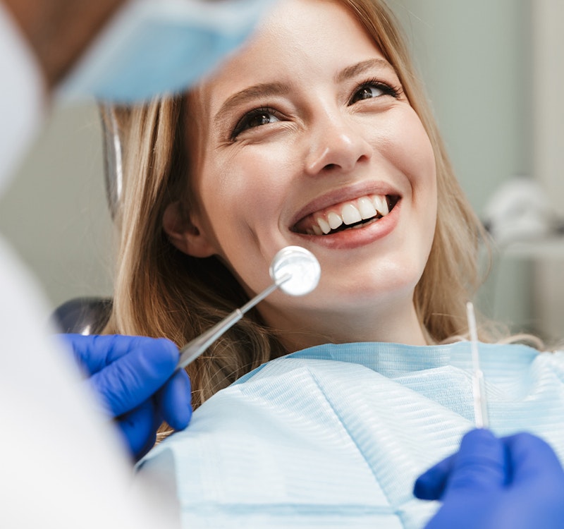 a woman with veneers at the dentist's office