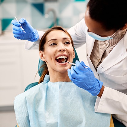 Smiling cosmetic dentistry patient receiving treatment