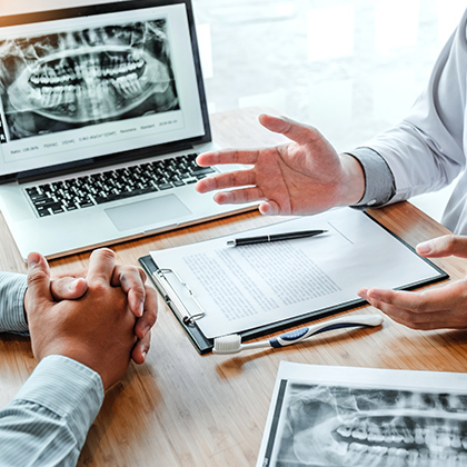 Dentist and patient discussing care