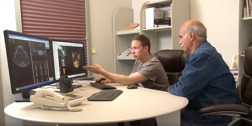 our dentist looking at scans on a monitor