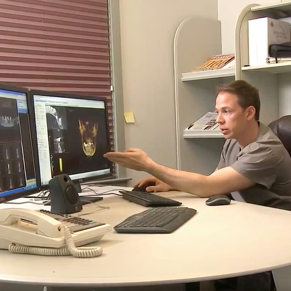 our dentist looking at scans on a monitor