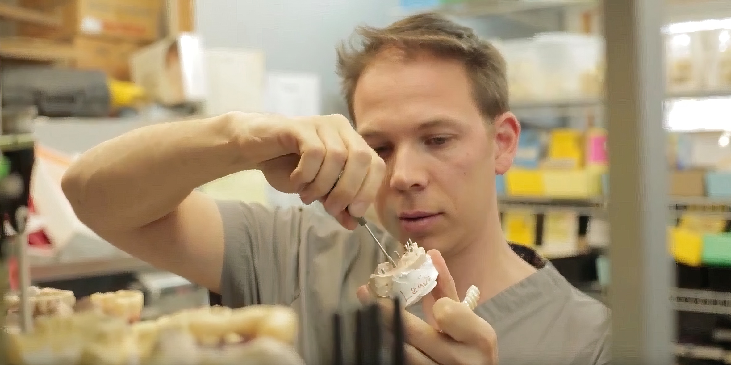 Dentist working on implant model