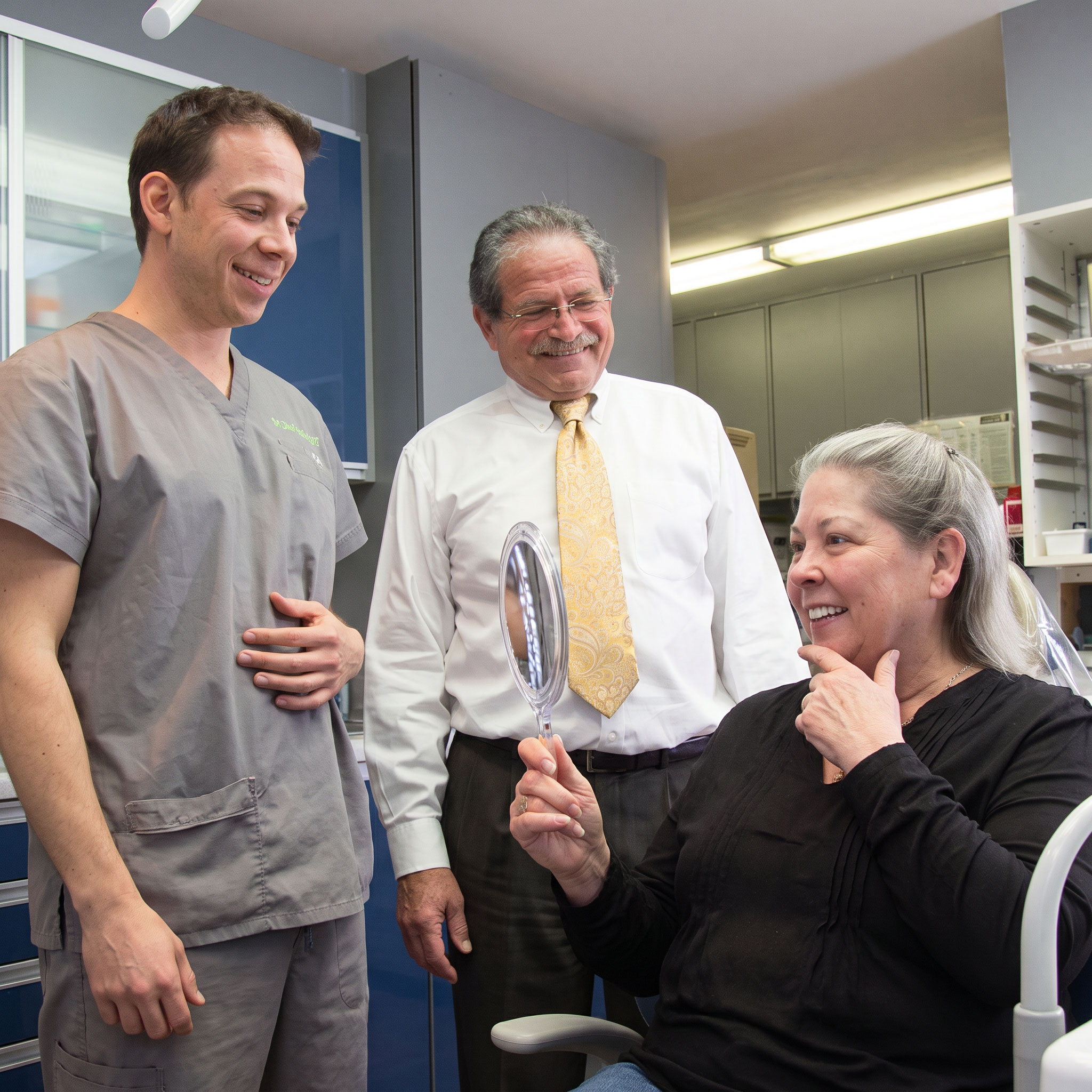 Drs. Alex and Jason Hecht speaking with patient