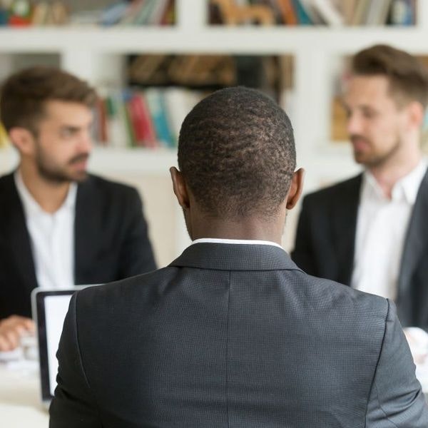 Three men in suits talking