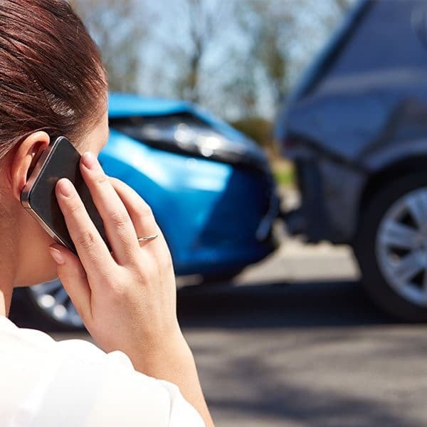 woman on the phone with an attorney after a car accident