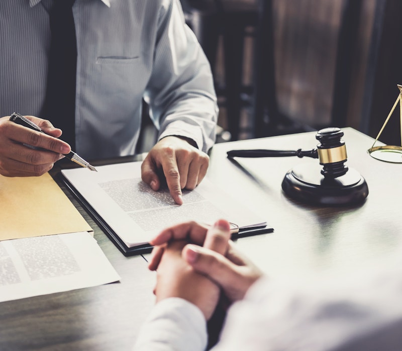 a lawyer going over documents with a client