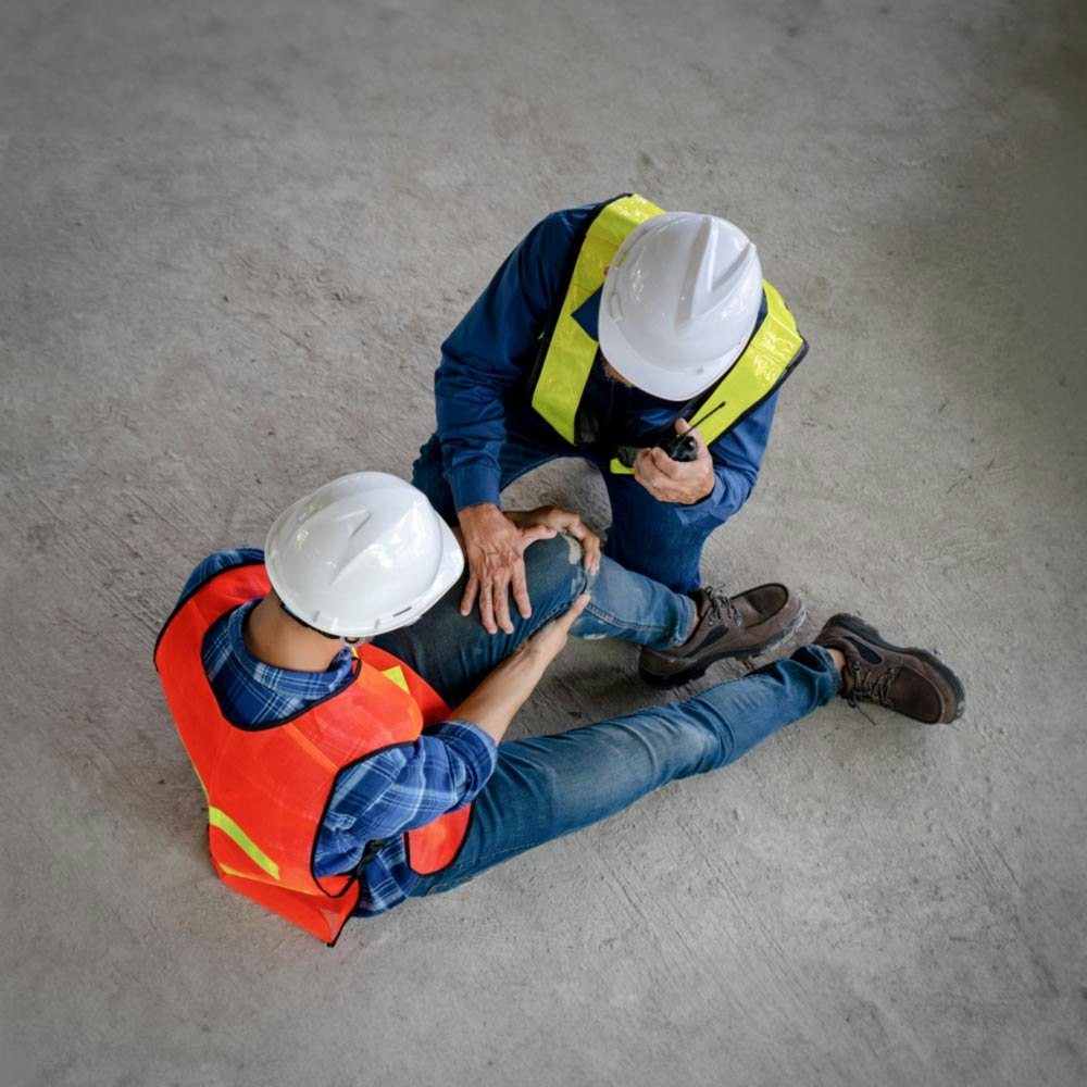 Construction worker aiding an injured construction worker